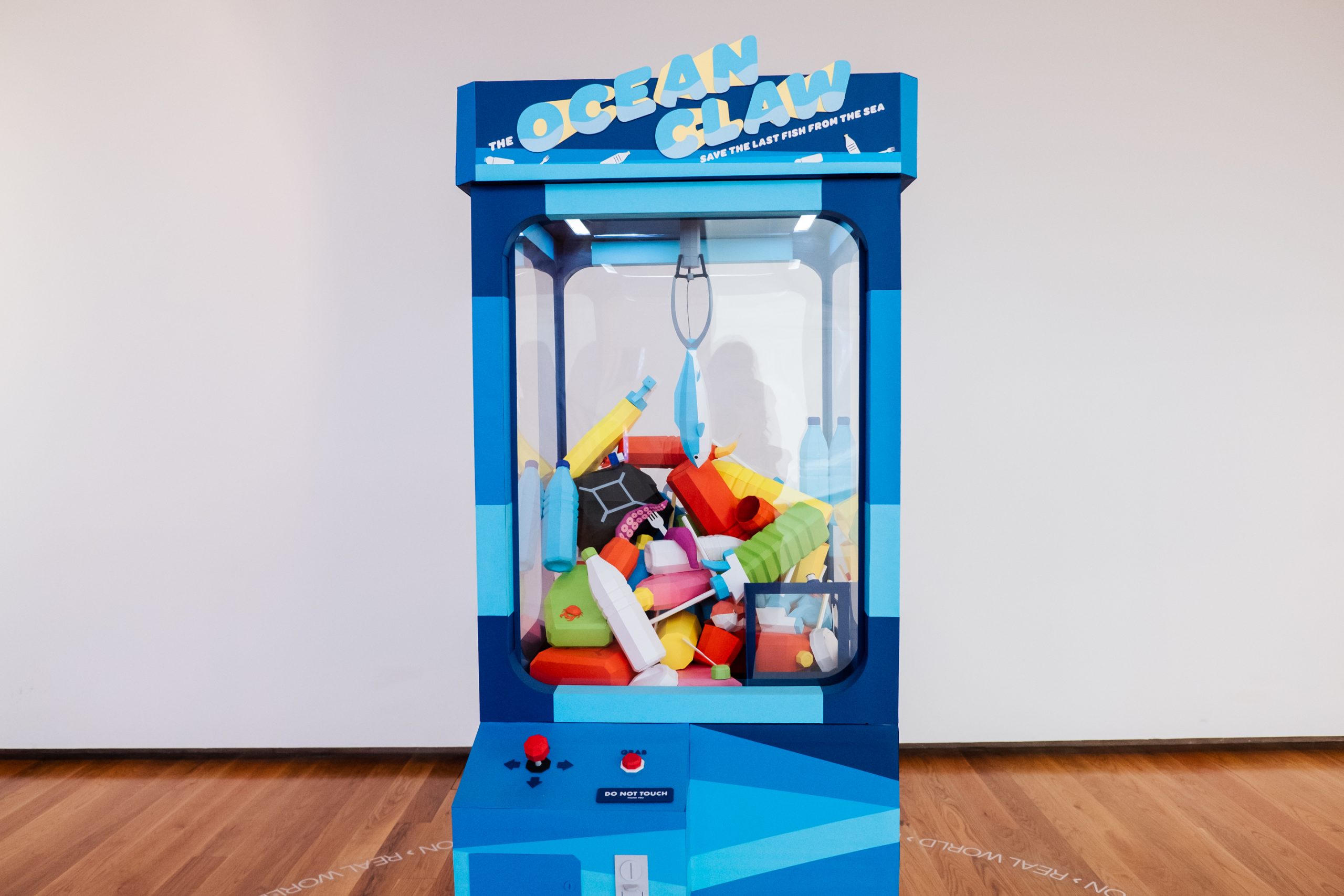 claw machine with plastic and fishes inside